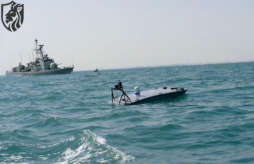 A MANTAS T-12 unmanned surface vessel sails alongside Royal Bahrain Naval Force Abdulrahman Al Fadhel during a joint exercise between U.S. 5th Fleet Command and Bahraini forces. (Mazen Mahdi/AFP via Getty Images)