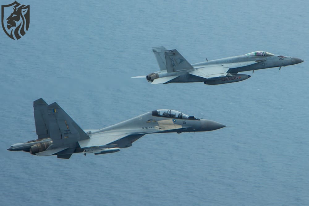 An F/A-18E Super Hornet and a Royal Malaysian Air Force SU-30MKM/Flanker H, fly in formation above the aircraft carrier USS Carl Vinson (CVN 70) during a bi-lateral exercise aimed at developing and enhancing security ties and partnerships with the Malaysian Royal Military. The Carl Vinson Strike Group is deployed to the U.S. 7th Fleet area of operations supporting security and stability in the Indo-Asia-Pacific region. (U.S. Navy photo by Lieutenant Jonathan Pfaff/Released)